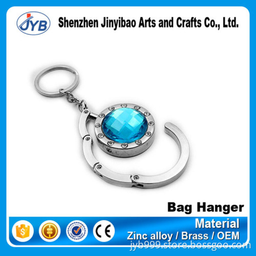beautiful design metal round shape foldable bag hanger on table top
